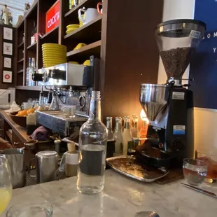 a coffee shop counter with a variety of drinks
