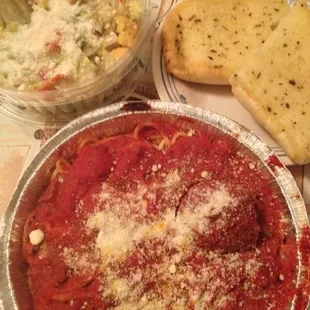 a plate of spaghetti and a bowl of salad