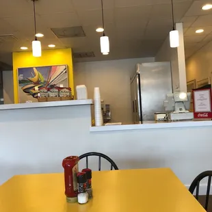 a yellow table and chairs