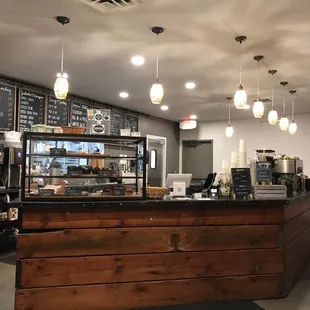 a counter with a menu on the wall