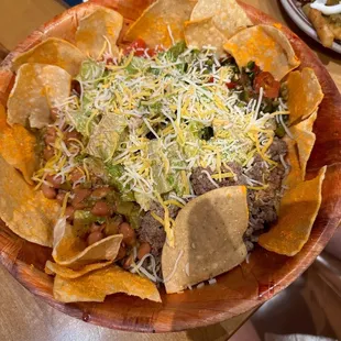 a plate of nachos with cheese and salsa