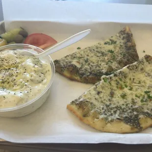 Cheese and zaatar flat pie with 'cucumber salad' which is more like tzatziki/ yogurt dip