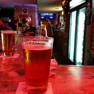 a pint of beer on a bar