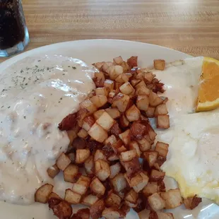 Biscuits and gravy with diced potatoes and eggs