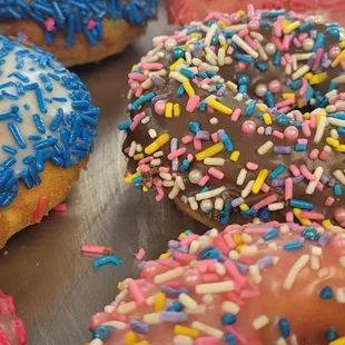 cake donuts with sprinkles on top. different flavor frosting.