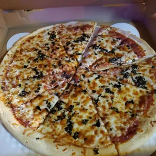 Large cheese pizza with extra cheese and basil.