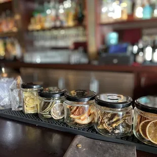 a row of jars filled with spices