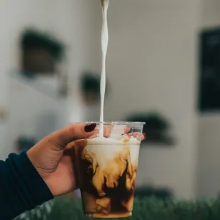 milk being poured into a cup