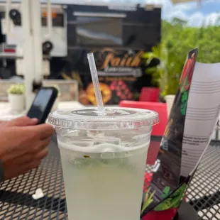 a drink in a plastic cup with a straw