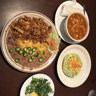 Menudo, guacamole tostada, chorizo, eggs, and papas.