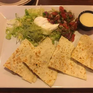 Quesadilla, pico, guacamole, sour cream, and cheese dip.