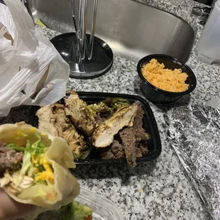 a hand holding a burrito