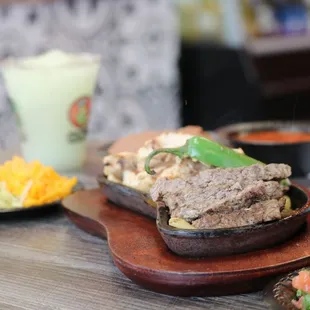 a steak sandwich with a side of chips