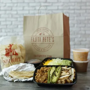 a lunch of chicken, tortillas, and guacamole