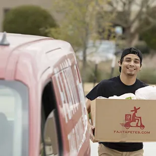 a man carrying a box of food
