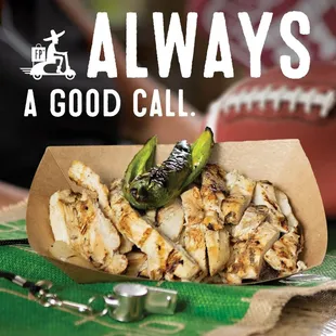 a bowl of food with a football in the background