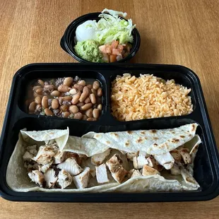 Two Amigos Plate with Two Chicken Tacos, Charro Beans, Mex Rice, and Taco Toppings (Chips &amp; Salsa Included But Shown Separately)