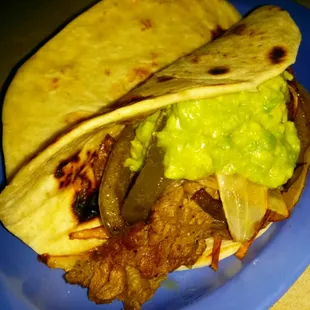 Beef fajita with guacamole , grilled onions and peppers...