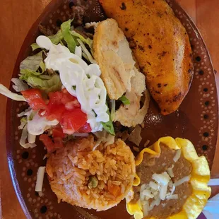 Combo with Mexican rice, refried beans, birria taco and a gordita with Carne asada.