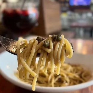 Chicken Piccata sauce and capers on spaghetti