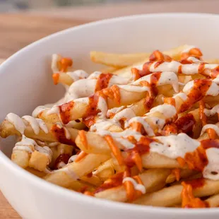 a bowl of fries with sauce