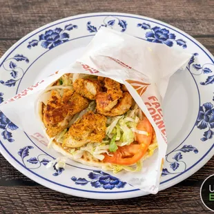a closeup of a falafel wrap on a plate