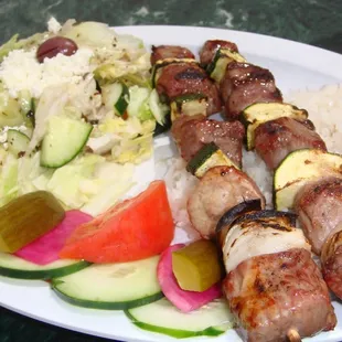lamb kabob with green salad and rice