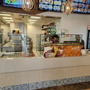 The overview of the counter and kitchen beyond