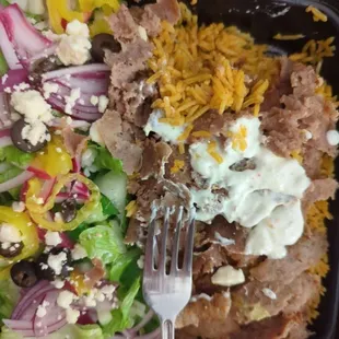 Gyro Platter - Gyro Meat atop Seasoned Rice and a side Greek Salad. Included Taziki sauce and Greek Dressing, on the side.