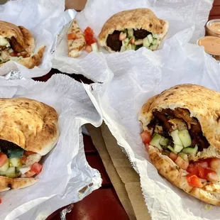 four pita sandwiches on a table