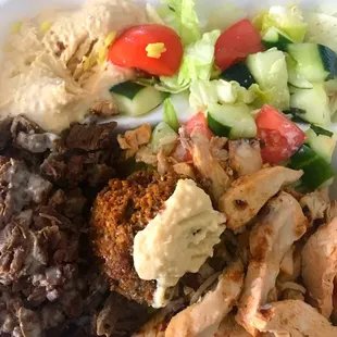 Mixed Plate with chicken and beef, rice, falafel and salad.