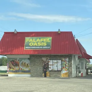 a man standing in front of a restaurant