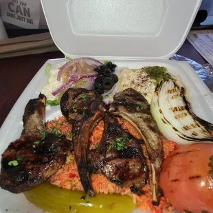 grilled meat and vegetables in a styrofoam container
