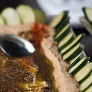 Hummus platters served the traditional way topped with za&apos;atar, paprika and olive oil