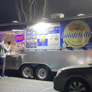 The well lit area around the food truck.