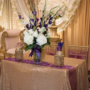 a gold table with purple and white flowers