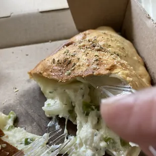 a person eating a piece of pizza