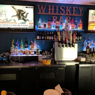 a bar with several televisions