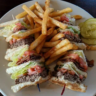 a plate of sandwiches and french fries