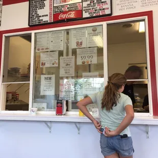 a woman standing in front of a window