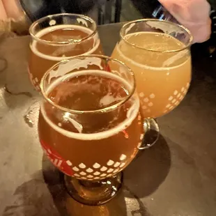 three glasses of beer on a table