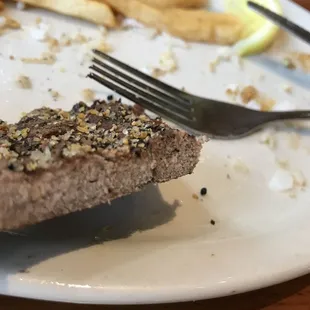 half eaten steak and fries