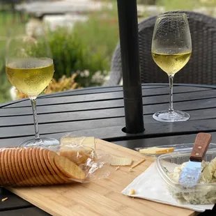 two glasses of wine and a cheese board