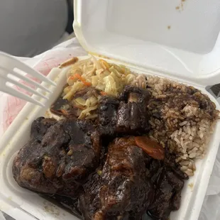 Oxtails with Rice and beans and Cabbage.