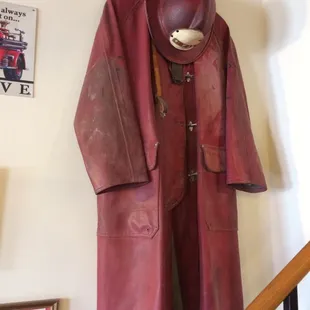 a red leather coat hanging on a wall