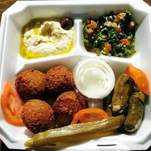 Vegetarian falafel plate: hummus, tabouli, falafel and dipping sauce, vegetarian grape leaves (baba ghanouj and pita not shown).
