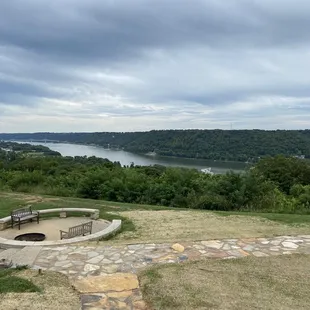 a fire pit overlooking a lake