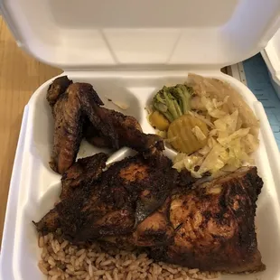 Jerk chicken, peas and rice and cabbage.