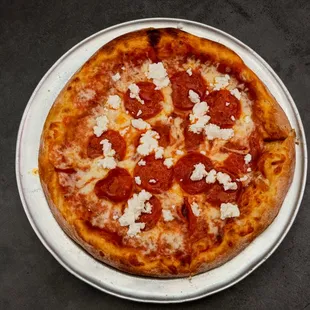 a pepperoni pizza on a plate