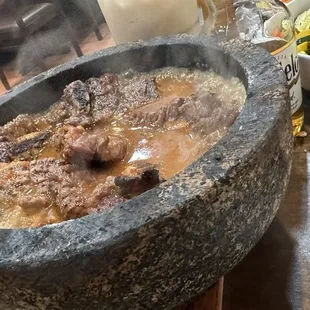 a large stone bowl of food
